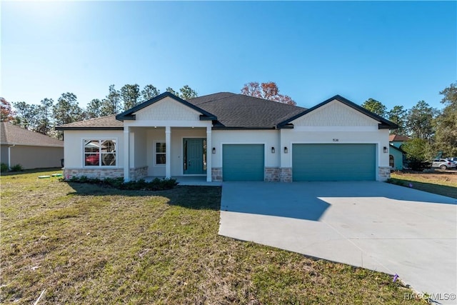 view of front of home with a garage, concrete driveway, stone siding, a front yard, and stucco siding