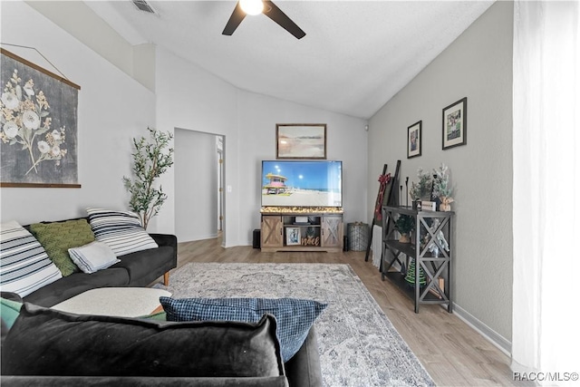 living room with light wood-type flooring, vaulted ceiling, and ceiling fan