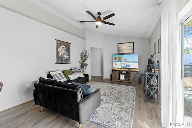 living room featuring hardwood / wood-style flooring, ceiling fan, and lofted ceiling