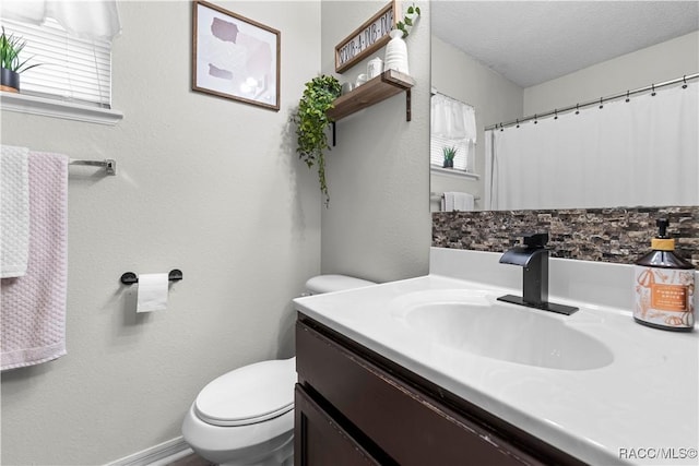 bathroom with vanity, a textured ceiling, and toilet