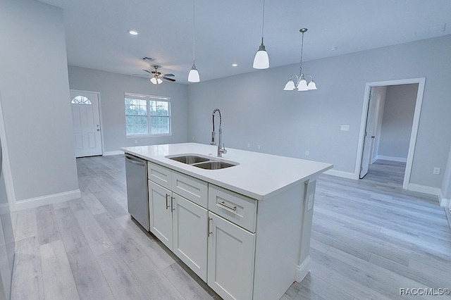 kitchen featuring white cabinets, ceiling fan with notable chandelier, sink, a center island with sink, and dishwasher