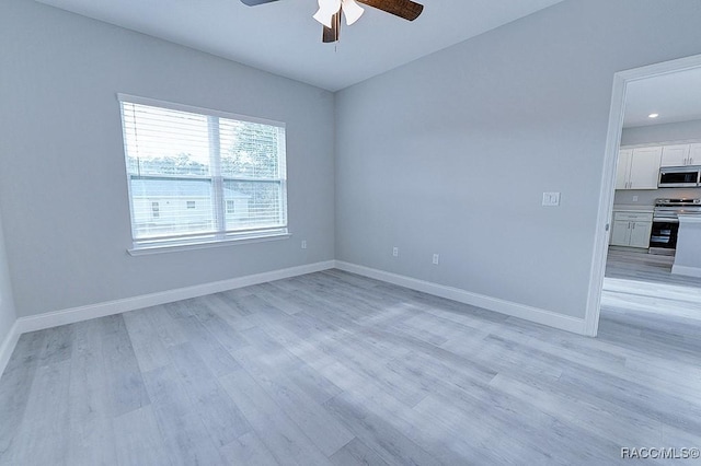 spare room with ceiling fan and light hardwood / wood-style flooring