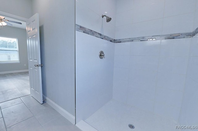 bathroom with a tile shower, ceiling fan, and tile patterned flooring