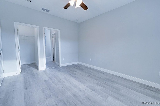 unfurnished bedroom with ceiling fan, a closet, and light hardwood / wood-style flooring