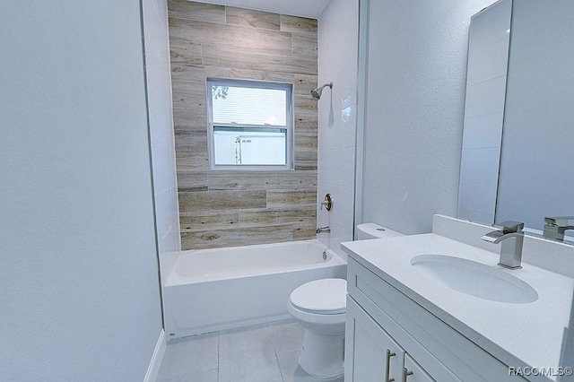 full bathroom with tile patterned flooring, vanity, tiled shower / bath combo, and toilet