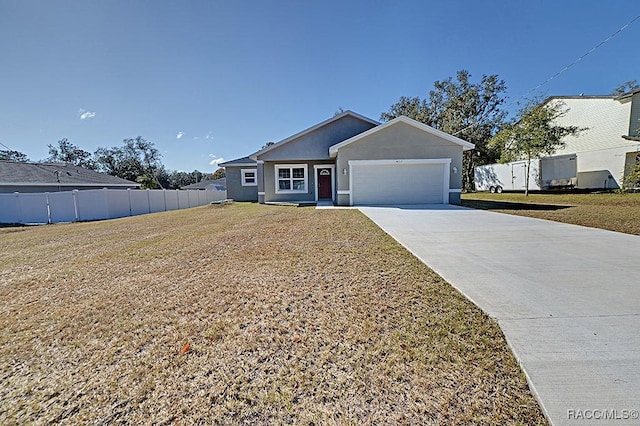 ranch-style house featuring a garage and a front lawn