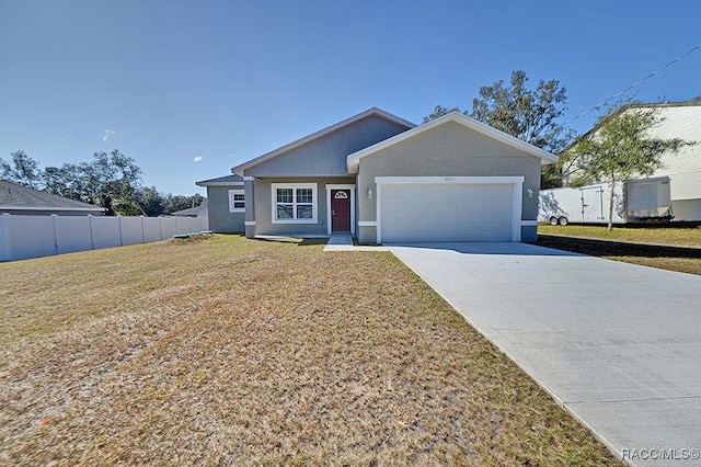 single story home with a garage and a front lawn