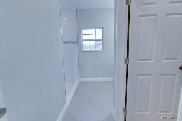 bathroom with tile patterned flooring and walk in shower