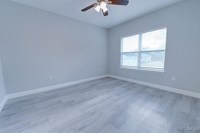 spare room featuring light wood-type flooring and ceiling fan