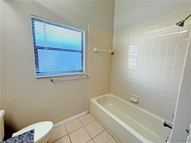 bathroom with tiled shower / bath combo, tile patterned floors, and toilet