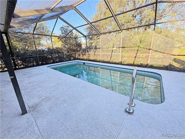 view of swimming pool with a lanai and a patio