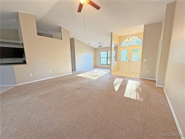 unfurnished living room with light colored carpet, ceiling fan, and a high ceiling