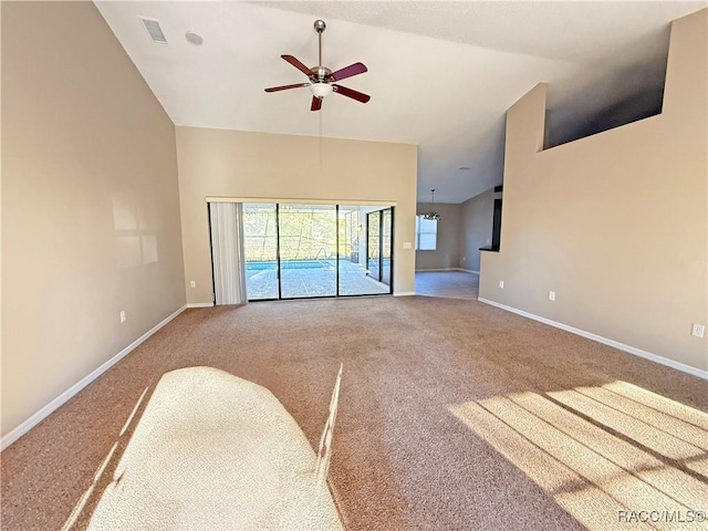 unfurnished living room with high vaulted ceiling, ceiling fan, and carpet