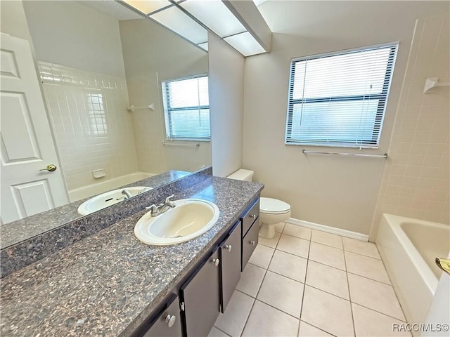 full bathroom featuring tile patterned floors, toilet, tiled shower / bath combo, and vanity