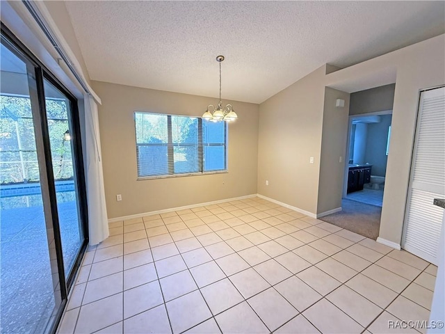 unfurnished dining area with light tile patterned flooring, a notable chandelier, and a textured ceiling