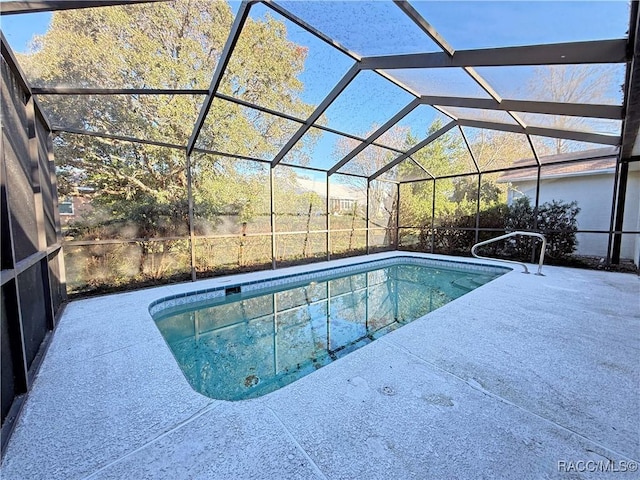 view of pool featuring a patio area and glass enclosure