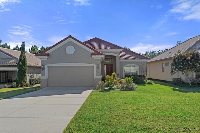 mediterranean / spanish house featuring a garage and a front lawn