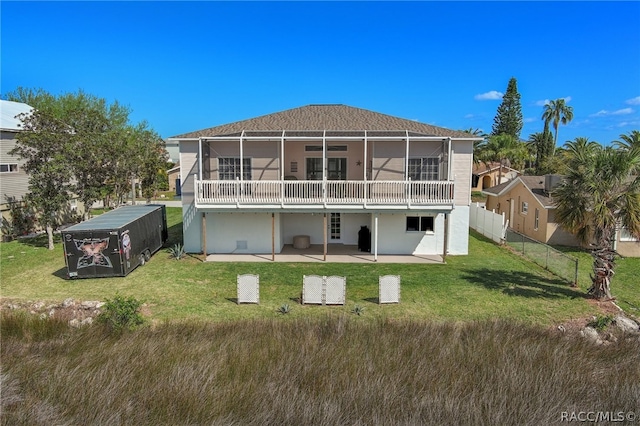 rear view of house featuring a yard and a patio