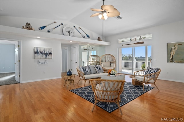 living room with ceiling fan, hardwood / wood-style floors, and lofted ceiling