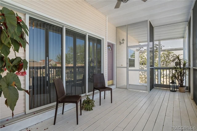 sunroom / solarium featuring ceiling fan