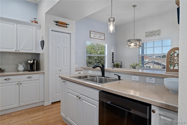 kitchen with white cabinetry, dishwasher, plenty of natural light, and sink