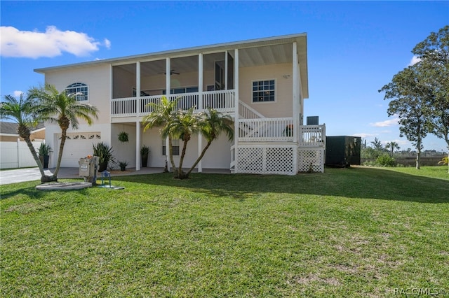 rear view of property with a garage and a yard