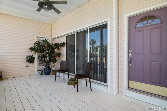 wooden deck with covered porch and ceiling fan