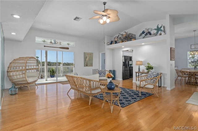 dining room featuring ceiling fan, high vaulted ceiling, a healthy amount of sunlight, and light wood-type flooring