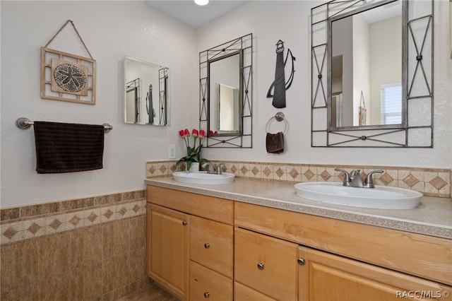 bathroom with vanity and tile walls