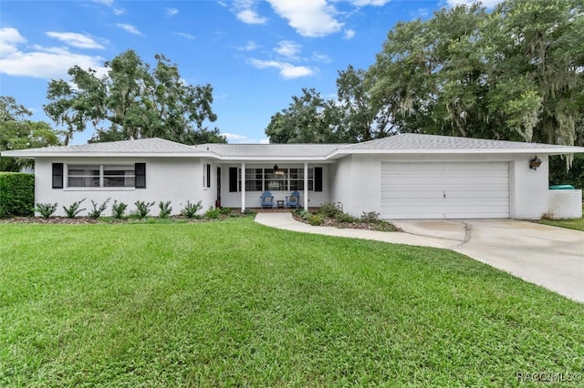 single story home with a garage and a front lawn