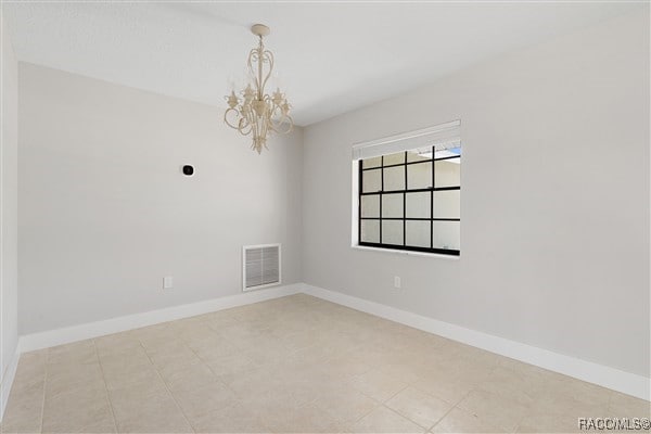 3929 N Sagomon Pt, Crystal River, FL 34428 - empty room featuring a chandelier and baseboards