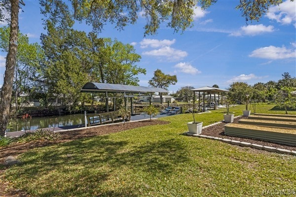 3929 N Sagomon Pt, Crystal River, FL 34428 - view of community featuring a yard, a dock, boat lift, and a water view