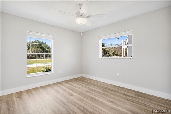 3929 N Sagomon Pt, Crystal River, FL 34428 - spare room with wood finished floors, healthy amount of natural light, and ceiling fan