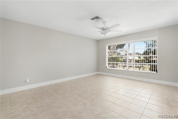 3929 N Sagomon Pt, Crystal River, FL 34428 - empty room with a ceiling fan and baseboards