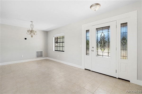 3929 N Sagomon Pt, Crystal River, FL 34428 - foyer featuring plenty of natural light and a chandelier