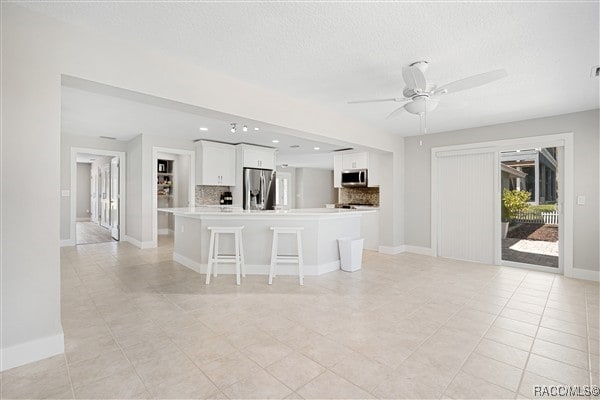 3929 N Sagomon Pt, Crystal River, FL 34428 - kitchen featuring stainless steel appliances, white cabinets, light tile patterned floors, a ceiling fan, and recessed lighting