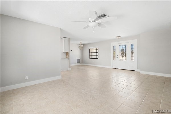 3929 N Sagomon Pt, Crystal River, FL 34428 - unfurnished living room with ceiling fan, a chandelier, and light tile patterned flooring