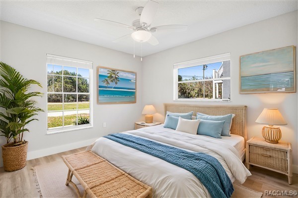 3929 N Sagomon Pt, Crystal River, FL 34428 - bedroom featuring multiple windows, wood finished floors, and ceiling fan