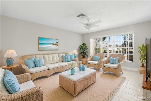 3929 N Sagomon Pt, Crystal River, FL 34428 - living area with light tile patterned flooring and a ceiling fan