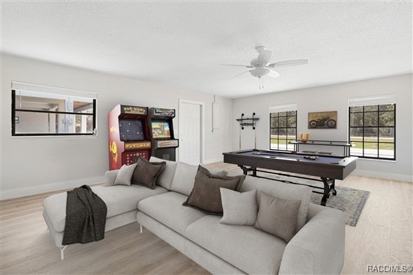 3929 N Sagomon Pt, Crystal River, FL 34428 - living room featuring light wood-type flooring, a ceiling fan, pool table, and a textured ceiling
