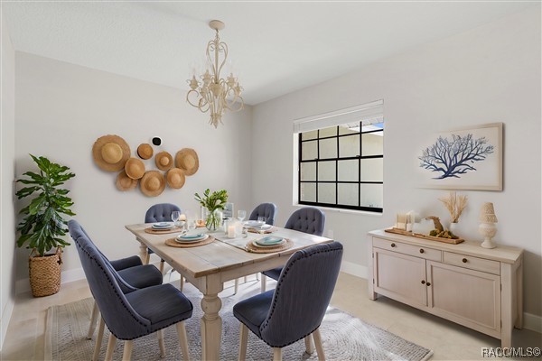 3929 N Sagomon Pt, Crystal River, FL 34428 - dining space with a chandelier and light tile patterned flooring
