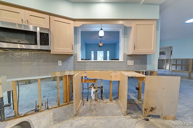 kitchen with backsplash, light brown cabinets, and decorative light fixtures