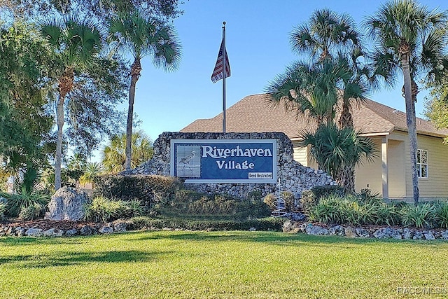 community sign featuring a yard