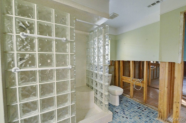 bathroom featuring a shower and toilet