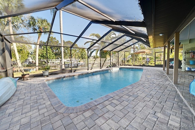 view of pool with a lanai and a patio