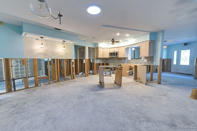 interior space featuring decorative backsplash, a kitchen island, decorative light fixtures, and ceiling fan