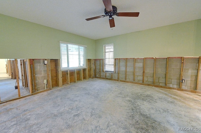 carpeted empty room featuring a textured ceiling and ceiling fan