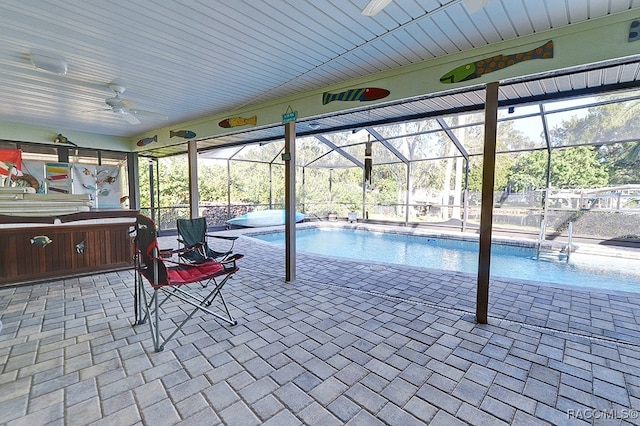 view of swimming pool with a patio, ceiling fan, and a lanai