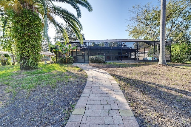 back of house with glass enclosure