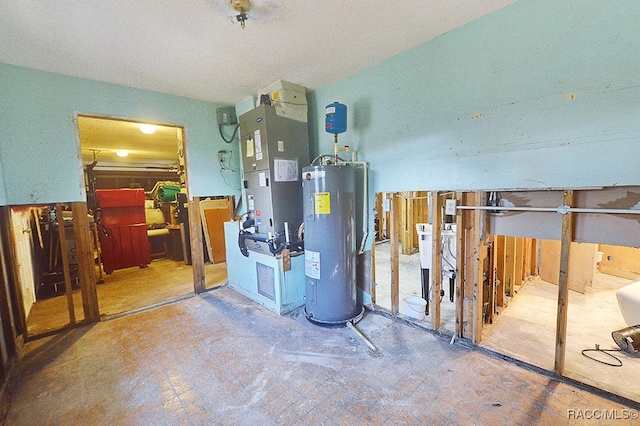 utility room featuring heating unit and electric water heater